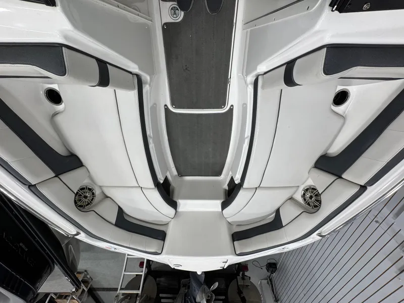 Slide: The Image of 2014 Yamaha Boats 212X interior, featuring sleek white seating and integrated speakers. - 15