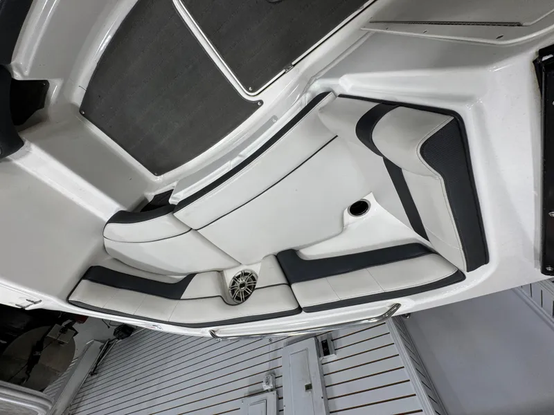 Slide: The Image of 2014 Yamaha Boats 212X interior with white and black seating, speaker, and sleek design. - 16