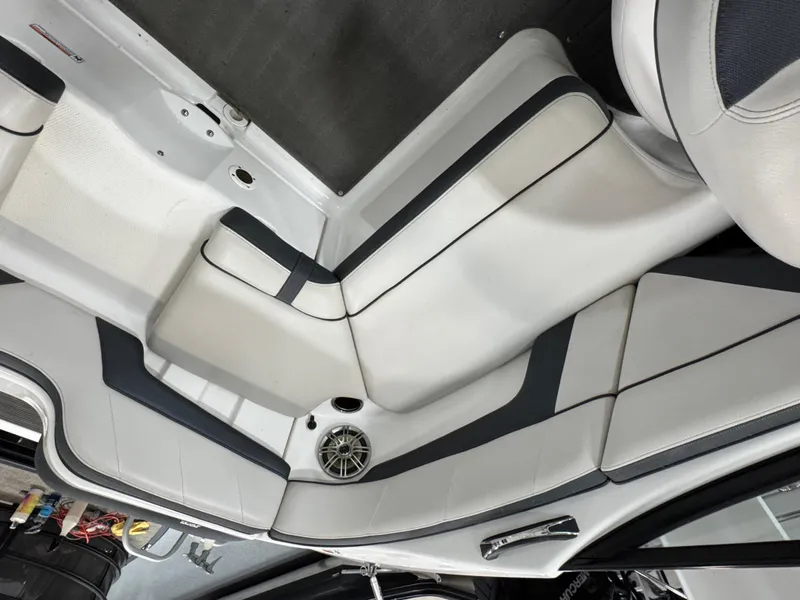 Slide: The Image of Interior seating of a 2014 Yamaha Boats 212X, featuring sleek white and black upholstery. - 4