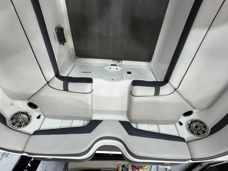 Slide: The Image of Interior view of a 2014 Yamaha Boats 212X, featuring white seating and built-in speakers. - 5
