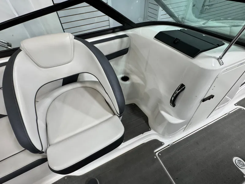 Slide: The Image of 2014 Yamaha Boats 212X interior with white and black seating, sleek design, and modern dashboard. - 7