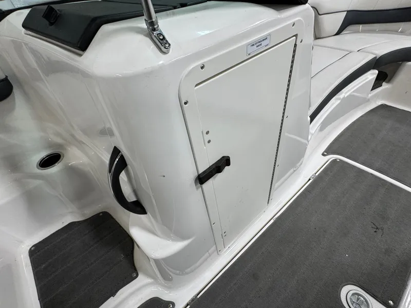 Slide: The Image of 2014 Yamaha Boats 212X interior, featuring storage compartment and seating area. - 9