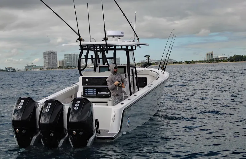 Slide: The Image of 2026 Reef Runner 340 boat with triple engines on open water. - 1