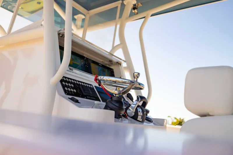 Slide: The Image of Helm of 2026 Reef Runner 340 boat with modern controls and steering wheel. - 12