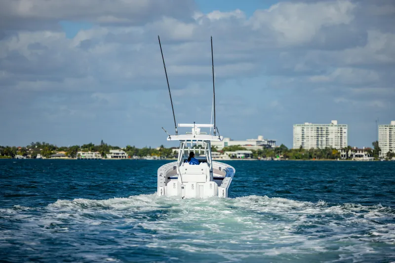 Slide: The Image of Reef Runner 340 boat cruising on open water, 2026 model. - 6