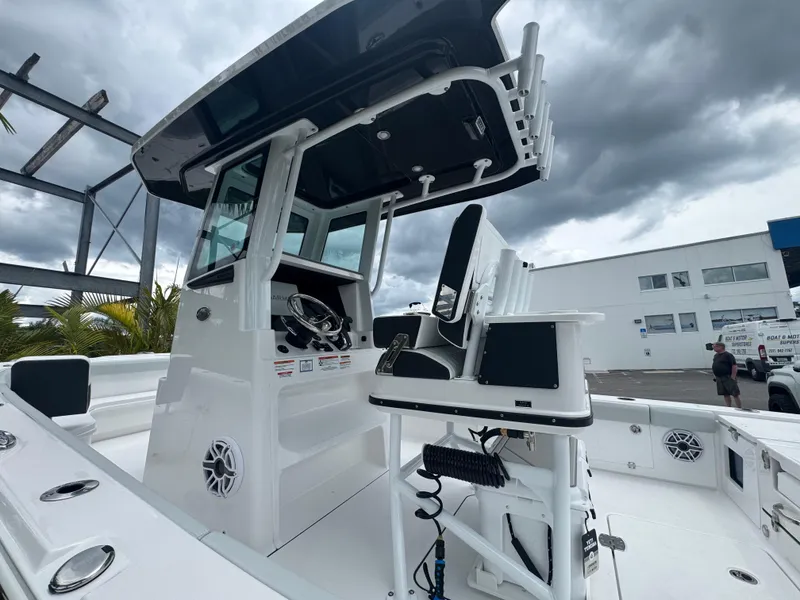 Slide: The Image of 2026 Blackfin 262 HB boat with modern helm and seating under cloudy sky. - 11