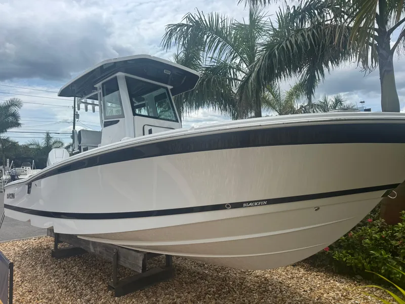 Slide: The Image of 2026 Blackfin 262 HB boat displayed outdoors with palm trees in the background. - 14