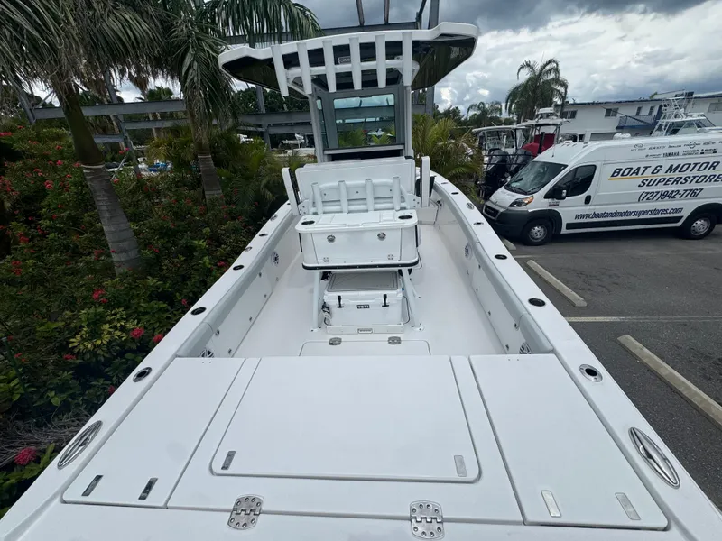 Slide: The Image of 2026 Blackfin 262 HB boat with spacious deck, parked near palm trees and a service van. - 16