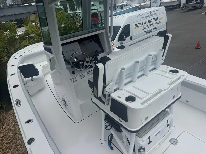 Slide: The Image of 2026 Blackfin 262 HB boat with helm station and seating, parked near a service van. - 20
