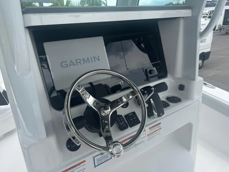 Slide: The Image of 2026 Blackfin 262 HB helm with Garmin navigation system and sleek steering wheel. - 25