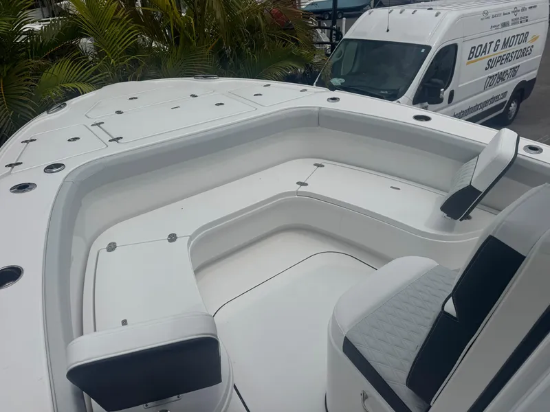 Slide: The Image of 2026 Blackfin 262 HB boat with spacious seating area, parked near a service van. - 29