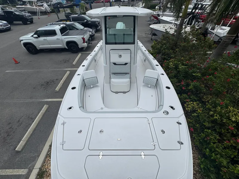 Slide: The Image of 2026 Blackfin 262 HB boat in parking lot, surrounded by vehicles and greenery. - 32