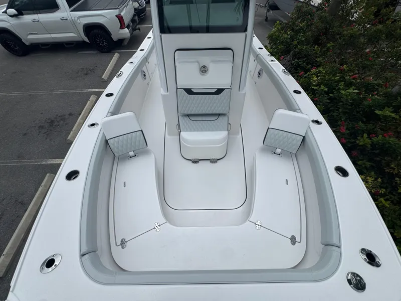Slide: The Image of 2026 Blackfin 262 HB boat interior with white seating and storage compartments. - 33