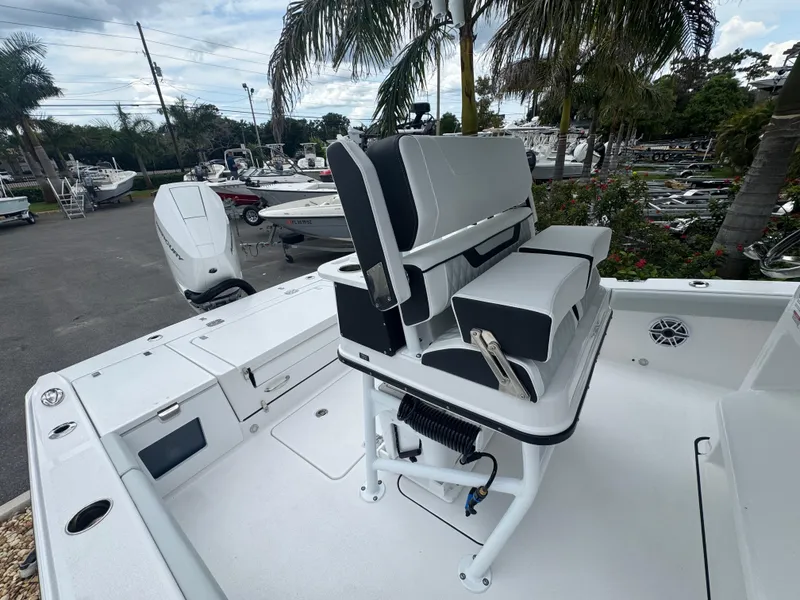 Slide: The Image of 2026 Blackfin 262 HB boat with sleek seating, docked near palm trees. - 44