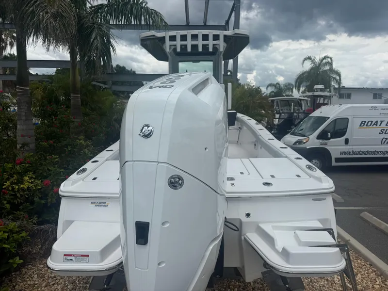 Slide: The Image of 2026 Blackfin 262 HB boat with powerful outboard motor, parked near palm trees. - 5