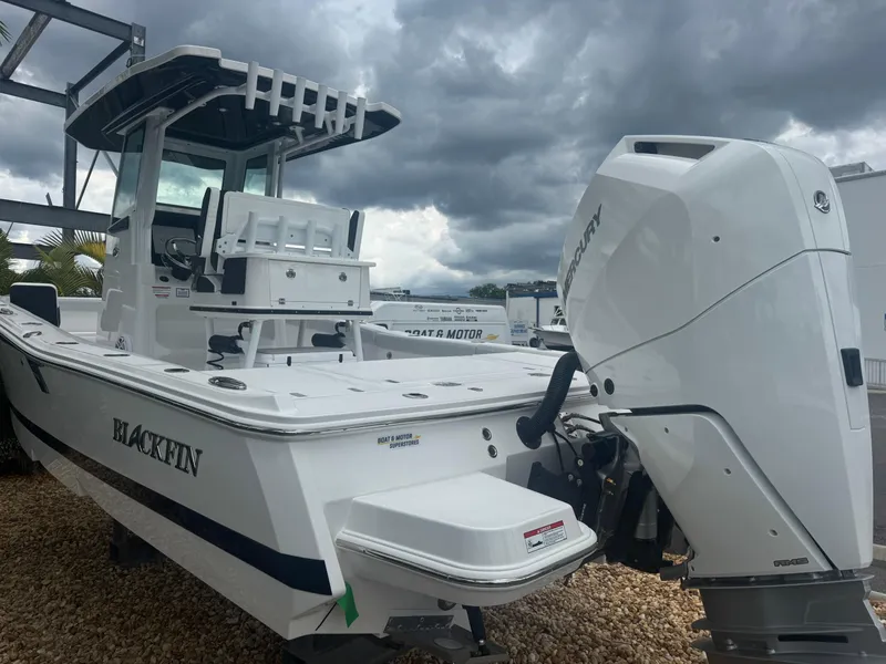 Slide: The Image of 2026 Blackfin 262 HB boat with powerful outboard motor under cloudy skies. - 6