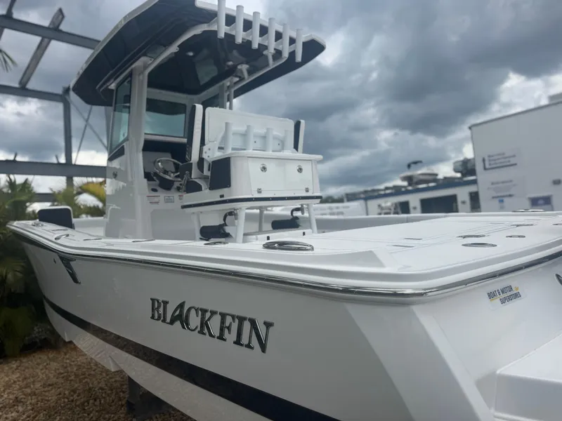 Slide: The Image of 2026 Blackfin 262 HB boat with sleek design under cloudy sky. - 7