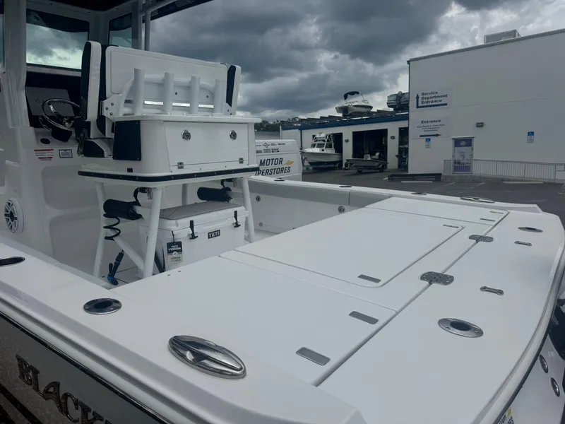 Slide: The Image of 2026 Blackfin 262 HB boat with fishing setup, docked under cloudy skies. - 8