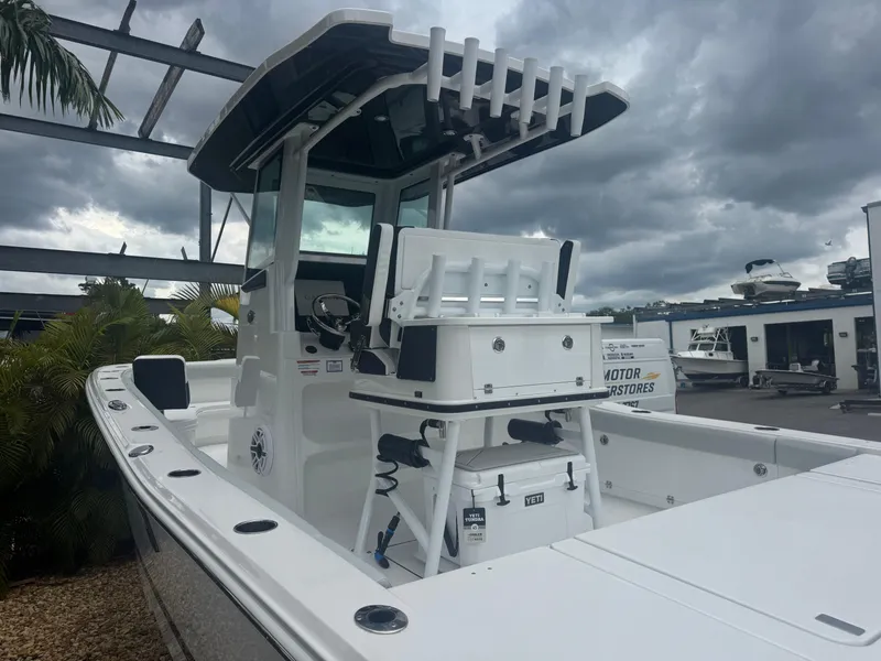 Slide: The Image of 2026 Blackfin 262 HB boat with center console, docked under cloudy skies. - 9