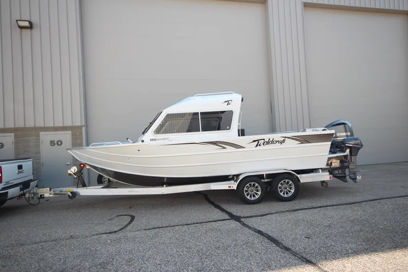 The Image of 2026 Weldcraft 220 Maverick DV boat on trailer, parked outside a building. - 3