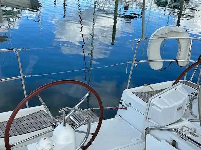 Slide: The Image of Cockpit of 2012 Jeanneau Sun Odyssey 379 sailboat with dual steering wheels. - 11