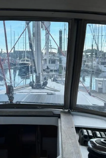 Slide: The Image of 2012 Jeanneau Sun Odyssey 379 sailboat docked in a marina, view from cockpit. - 13
