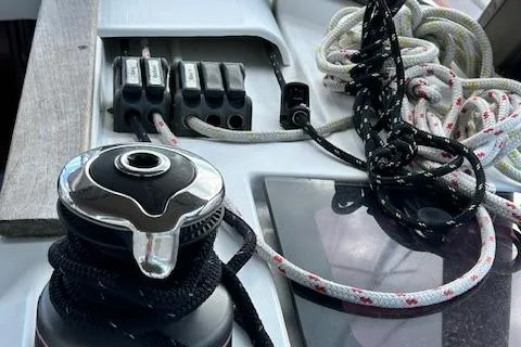 Slide: The Image of Deck equipment on a 2012 Jeanneau Sun Odyssey 379 sailboat, featuring winch and ropes. - 16