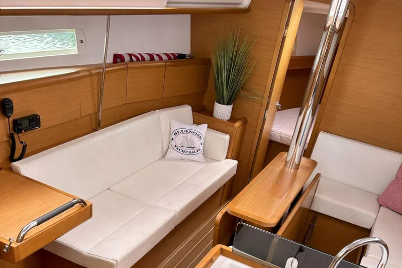 Slide: The Image of Interior of 2012 Jeanneau Sun Odyssey 379 sailboat with white seating and wooden accents. - 19