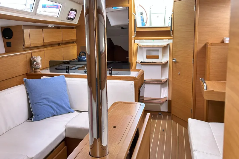 Slide: The Image of Interior of 2012 Jeanneau Sun Odyssey 379 sailboat with modern wood finish and cozy seating. - 24