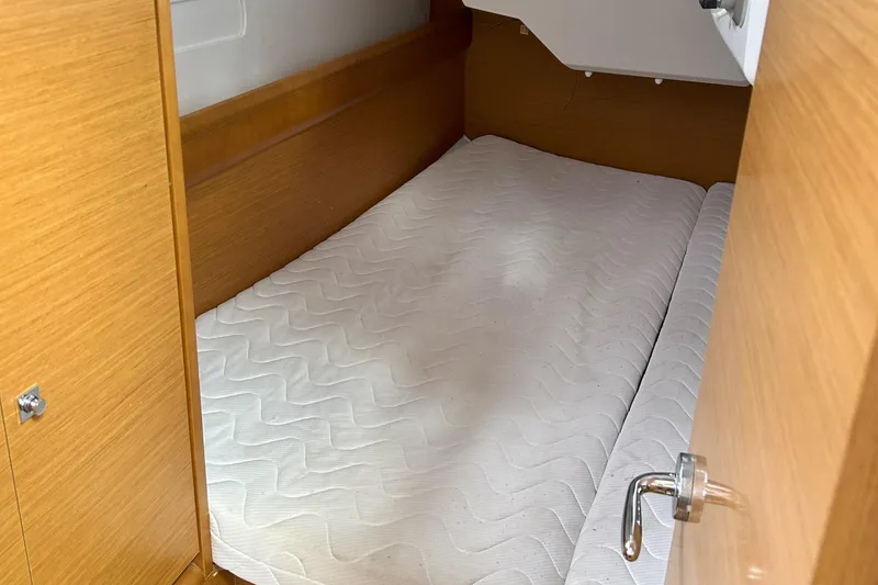 Slide: The Image of Cabin interior of 2012 Jeanneau Sun Odyssey 379 with a neatly made bed. - 30