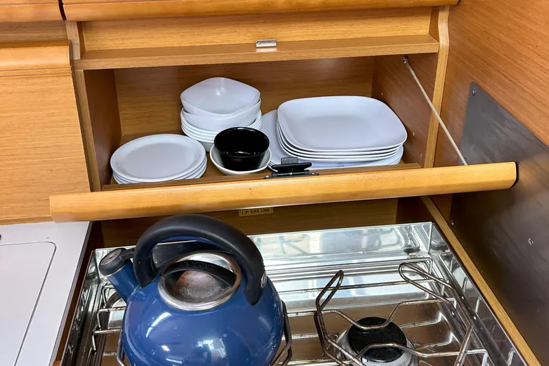 Slide: The Image of Galley of 2012 Jeanneau Sun Odyssey 379 with dishes and blue kettle. - 33