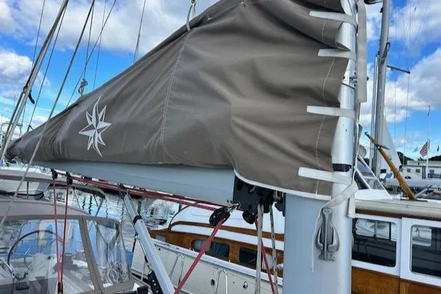 Slide: The Image of Jeanneau Sun Odyssey 379 sailboat, 2012 model, docked with sail cover, blue sky background. - 5