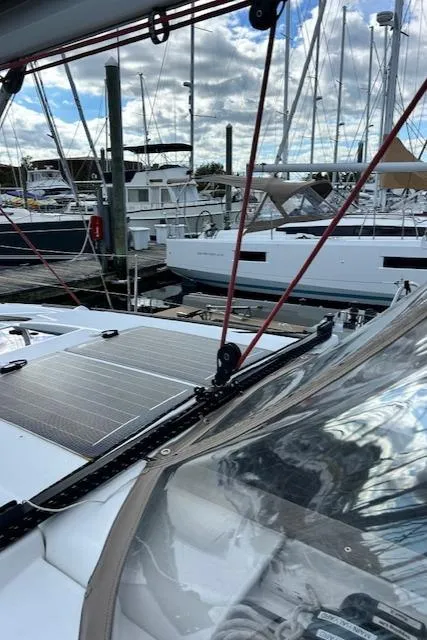 Slide: The Image of 2012 Jeanneau Sun Odyssey 379 sailboat docked at marina with solar panels. - 7