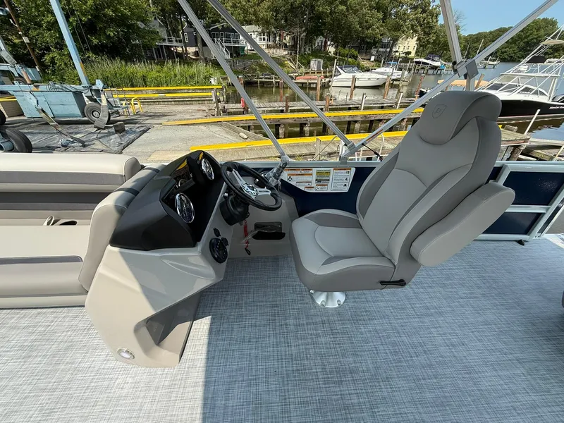 Slide: The Image of 2025 Premier 200 Sunscape RE XLC boat interior with captain's chair and control panel. - 6