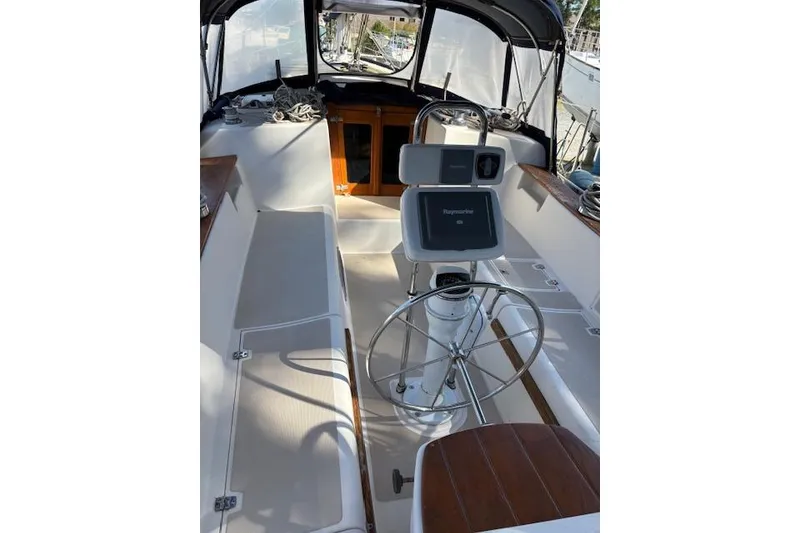 Slide: The Image of 1987 Island Packet 38 sailboat cockpit with steering wheel and navigation equipment. - 11