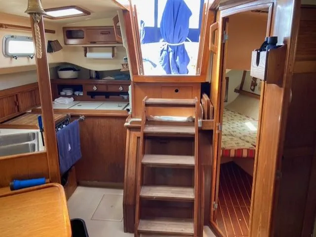 Slide: The Image of Interior of 1987 Island Packet 38 sailboat with wooden cabinetry and cozy cabin layout. - 13