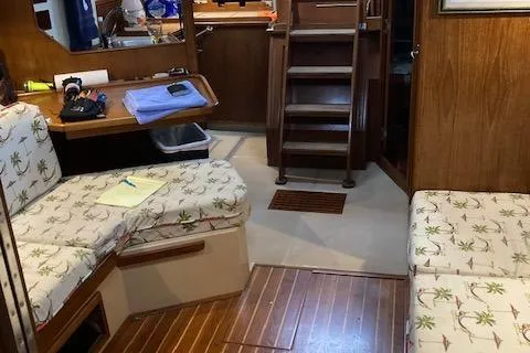 Slide: The Image of Interior of 1987 Island Packet 38 sailboat with wooden furnishings and patterned seating. - 14