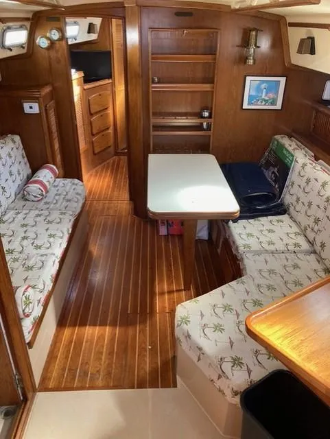 Slide: The Image of Interior of 1987 Island Packet 38 sailboat with wood finish and cozy seating area. - 17