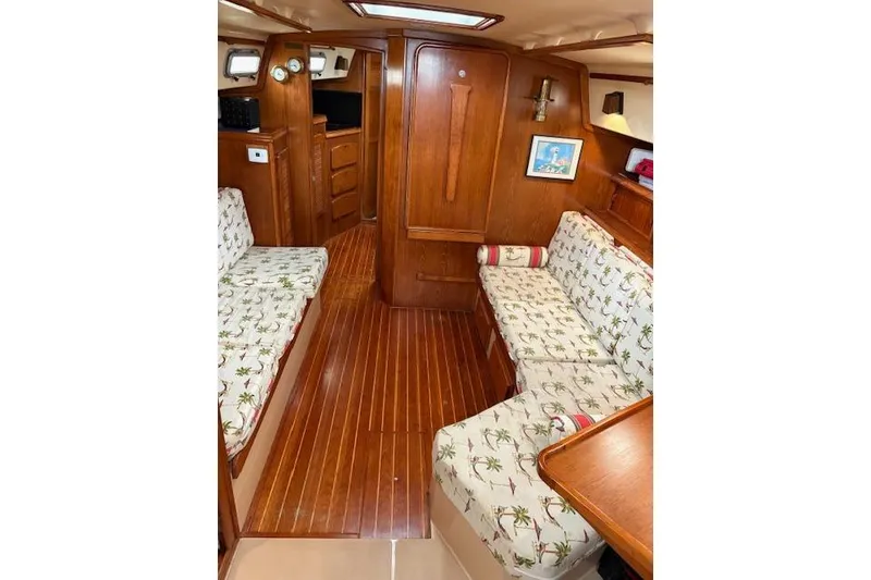 Slide: The Image of 1987 Island Packet 38 interior with wood paneling and patterned seating. - 19