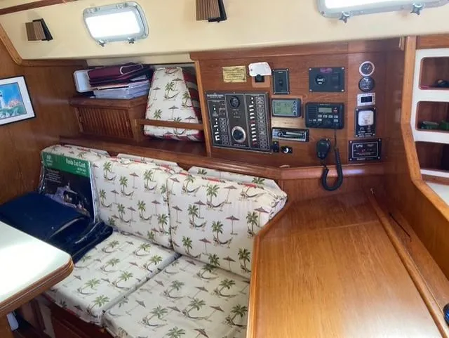 Slide: The Image of Interior of 1987 Island Packet 38 sailboat with tropical-themed cushions and navigation equipment. - 21