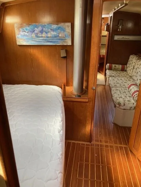 Slide: The Image of Interior of 1987 Island Packet 38 sailboat with cozy cabin and wooden flooring. - 26