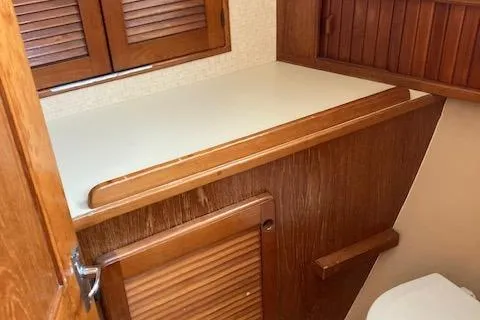 Slide: The Image of 1987 Island Packet 38 yacht interior with wooden cabinetry and countertop. - 30