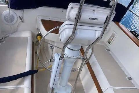 Slide: The Image of Cockpit of 1987 Island Packet 38 sailboat with steering wheel and seating. - 6
