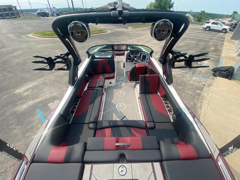 Slide: The Image of 2022 MasterCraft X24 boat interior with red and black seating, advanced sound system, and sleek design. - 13