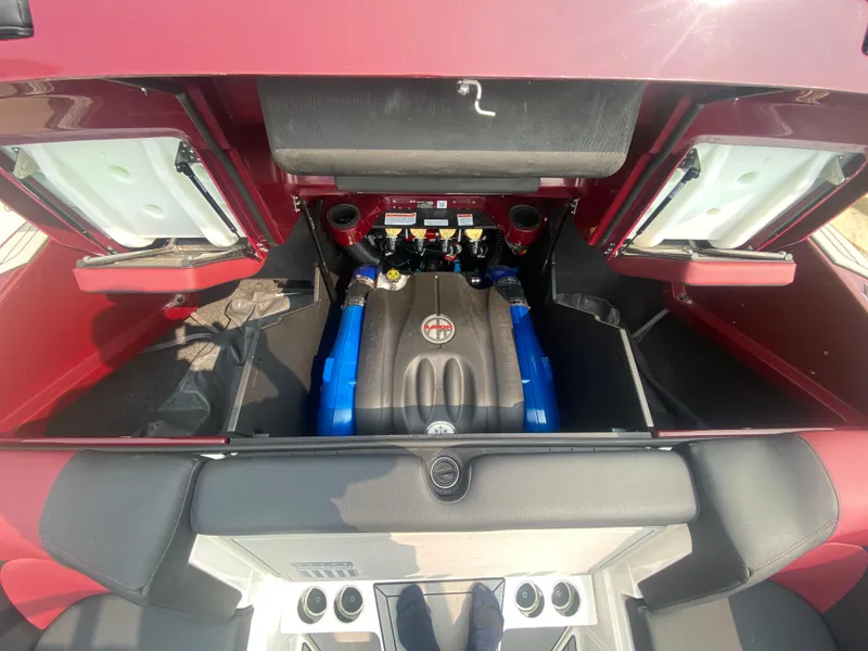 Slide: The Image of Engine compartment of a 2022 MasterCraft X24 boat, showcasing detailed interior components. - 21
