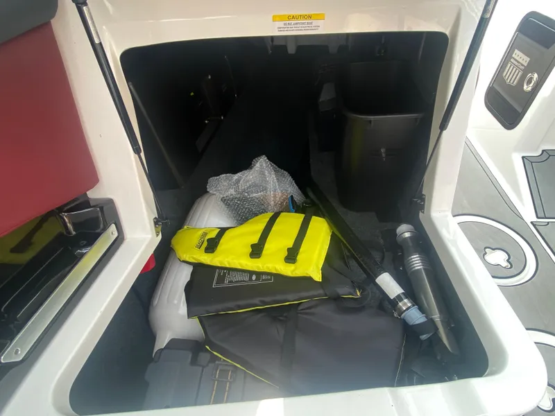 Slide: The Image of Storage compartment of 2022 MasterCraft X24 boat with safety gear and equipment. - 28