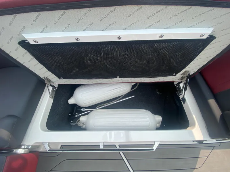 Slide: The Image of Storage compartment in 2022 MasterCraft X24 boat with fenders inside. - 32