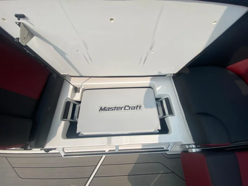 Slide: The Image of 2022 MasterCraft X24 boat storage compartment with logo, open view. - 33