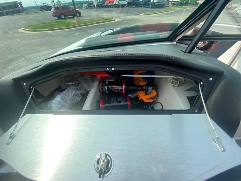 Slide: The Image of Storage compartment of a 2022 MasterCraft X24 boat, containing safety equipment and accessories. - 34