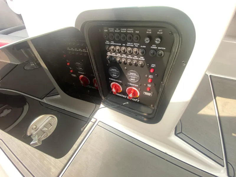 Slide: The Image of Control panel of 2022 MasterCraft X24 boat, featuring switches and dials. - 35